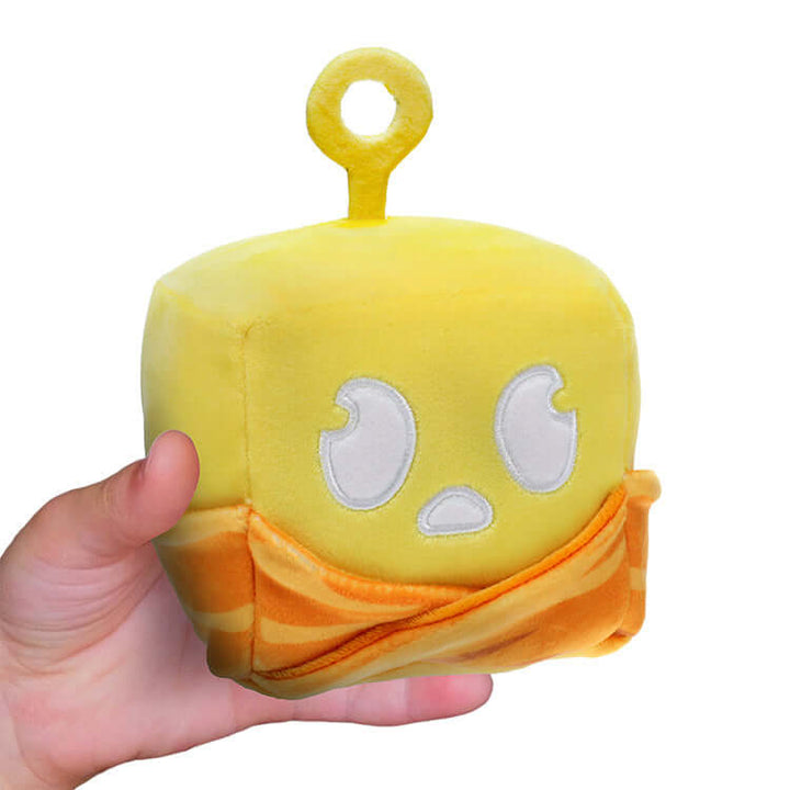 4-inch Blox Fruits Series 2 plush toy held in hand, featuring yellow character with detailed embroidery.