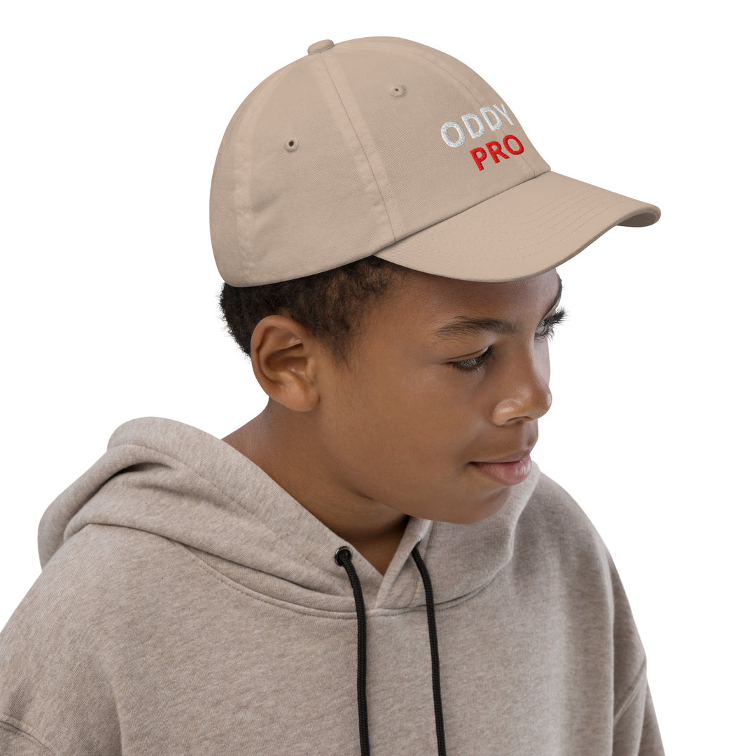 Oddy Pro Youth baseball cap worn by a boy, featuring an adjustable fit and stylish design.